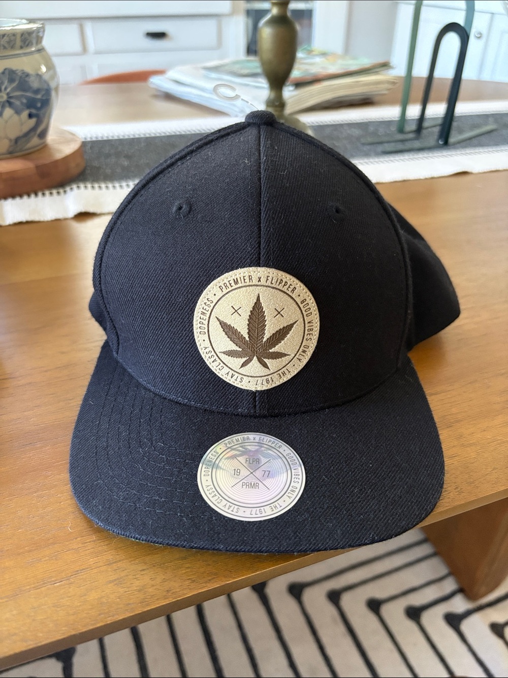 Black Premier Snapback Hat with “leaf” Emblem